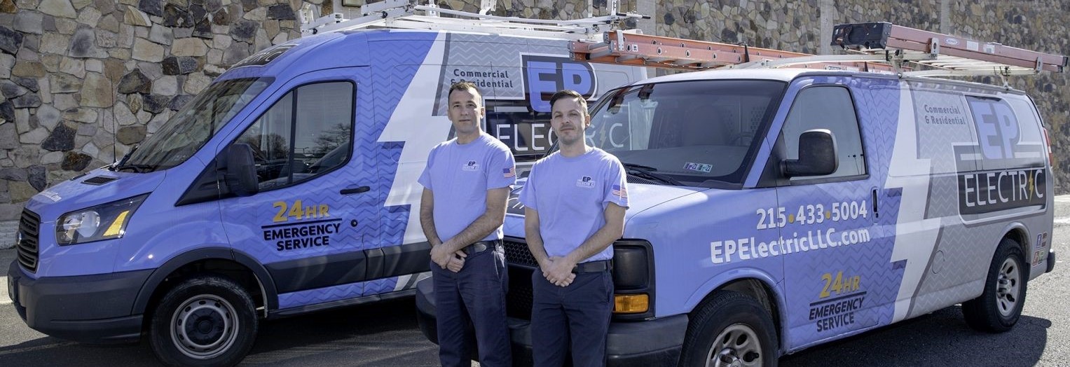 Two electricians in front of EP Van