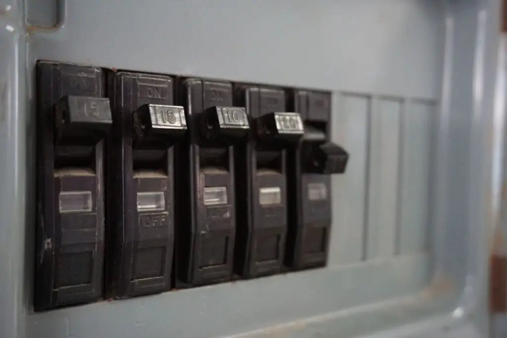 Breakers on an electric panel, one of the breakers is flipped